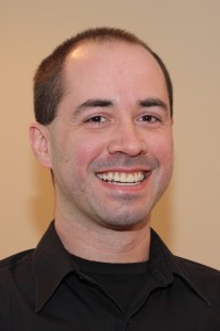 Portrait of John Borwick wearing a stylish black dress shirt